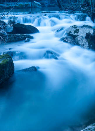 small mountain river waterfall in the evening on a long exposureの写真素材