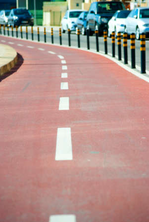 colored bicycle lane with separative enclosure from the main carriagewayの写真素材