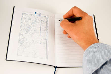 man's hand with a pen on the background of a diary
の写真素材
