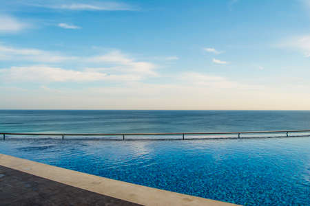 Pool with handrails and sea views
