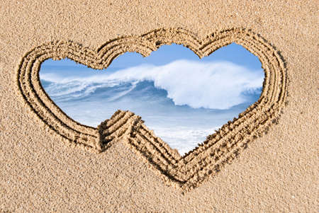 crest of a wave in the sand drawn on the heartの写真素材