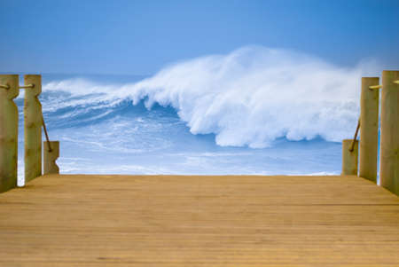 view of sea waves with a wooden bridgeの写真素材