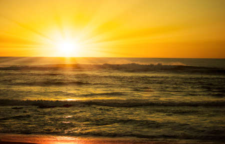 surf in the glow of the setting sunの写真素材