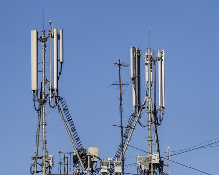 Telecommunication antennas on a blue sky background.