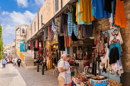 Tourists on shopping in a small bazaar on the famous Via Dolorosa in the Old City of Jerusalem.のeditorial素材