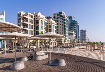 Man relaxing in the shade during a sunny day on Tel Aviv seafront.のeditorial素材