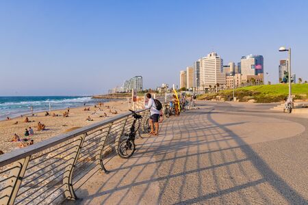 Tourists on Tel Aviv seafront promenade in a sunny summer afternoon.のeditorial素材