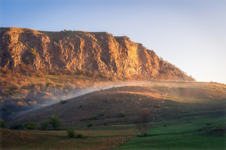 Landscape with morning fog on the hillside.の写真素材