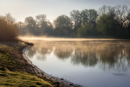 Morning fog over the river. Spring landscape with misty river.の写真素材