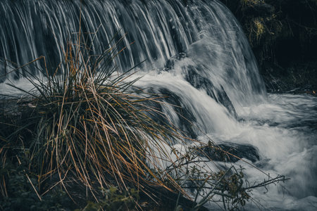 Toned image of a waterfall on the mountain river. Long exposure.の写真素材