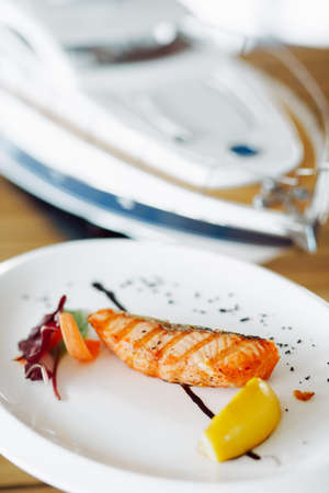 delicious grilled red fish on a white plate