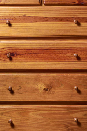 Traditional wooden chest of drawers pattern of closed drawers. Wood texture of cabinet that can be used as background.の写真素材