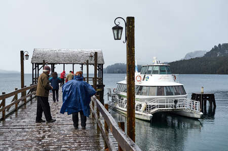 NEUQUÃN, ARGENTINA - SEPTEMBER 8, 2015: People at the pier near the Municipal Museum of Villa La Angostura with view of the Nahuel Huapi Lake.のeditorial素材