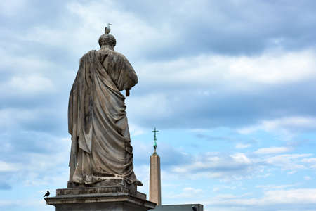 View of the back of the sculpture of Saint Peter and obelisk at Saint Peter's Square in the Vatican City in Rome, Italy.の写真素材
