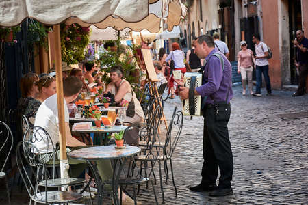 ROME, ITALY - MAY 17, 2017: A street artist playing his bandoneon for people on the street in Trastevere, Rome, Italy.のeditorial素材