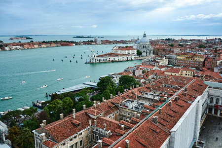 Cityscape of Venice, view of picturesque old buildings and Santa Maria della Salute Cathedral from the bell tower at Saint Mark's Square under beautiful blue cloudy sky.のeditorial素材