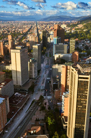 View of the city of Bogota from the top of the Colpatria building, with big avenue surrounded by office buildings and view of mountains behind.のeditorial素材