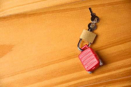 Keys and padlock locked on miniature toy suitcase. Concept of travel insurance, safe travel. Copyspace.の写真素材