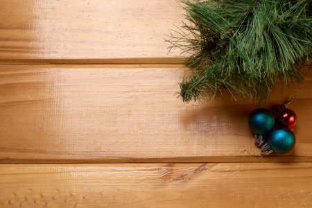 Top view of Christmas decoration on rustic wooden table. Christmas balls and tree on the table, background with copy space for text.の写真素材
