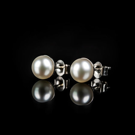 Silver earrings with pearls on a black background - luxury jewelryの素材
