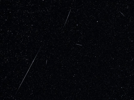 Lyrid meteor shower streaks across a star-filled night skyの写真素材