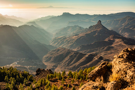 Dramatic landscape of Roque Bentayga, mountains and valleys from La Goleta, Roque Nublo, Gran Canaria, Spain. Sunset in backgroundの写真素材