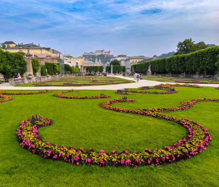 Salzburg, Austria, 06.10.2025: Mirabell Palace gardens with tourists walking around flower beds....