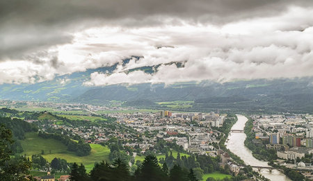 View of Innsbruck from Nordkette mountain range, Austrian alps. Along the river Inn, in a green...
