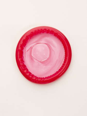 condom red isolated on a white backgroundの写真素材