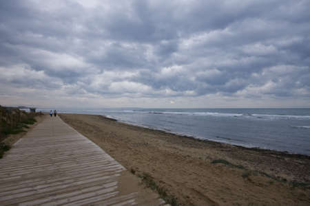 A wooden walkway along the sea on a winter day 