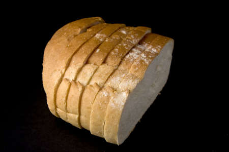 Sample a piece of sliced bread on a black background.の写真素材