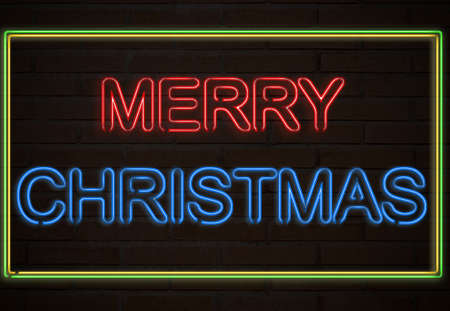 A neon sign on a brick wall say Merry Christmas.の写真素材
