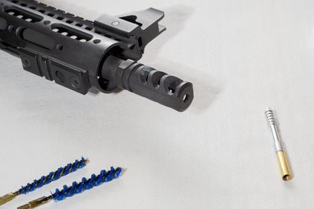 Gunsmith cleaning gun rifle assemble maintenance. White background