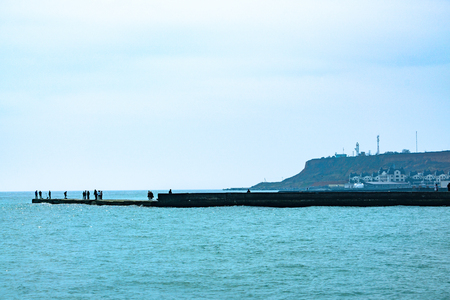 People walk along the wharf of the bayの写真素材