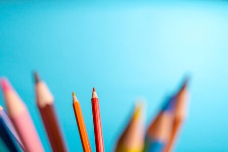 Color pencils on a blue background, soft focus. Blank for art school, back to school. Copy spaceの写真素材