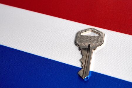 Silver key on the flag of Netherlands. Close-up, copy spaceの写真素材