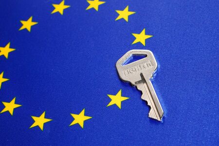 Silver key on the flag of European Union. Close-up, copy spaceの写真素材