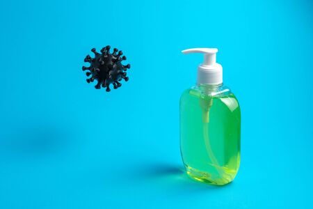 Coronavirus and liquid soap on a blue background. Concept for hospitals, medical centers, laboratories. Copy spaceの写真素材