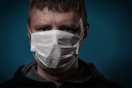 Portrait of a forty year old man in a medical mask. Pandemic COVID-19の写真素材