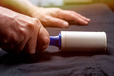 Someone is cleaning clothes with a cleaning rollerの写真素材