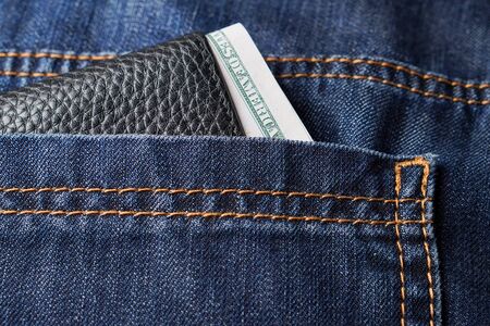 Black leather wallet in jeans pocket. Soft focusの写真素材