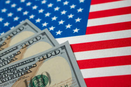 USA national flag and the dollar bills. Business and finance concept, soft focus