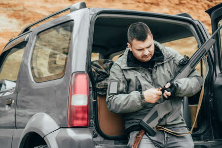 Private military contractor or hunter. Man reload rifleの写真素材