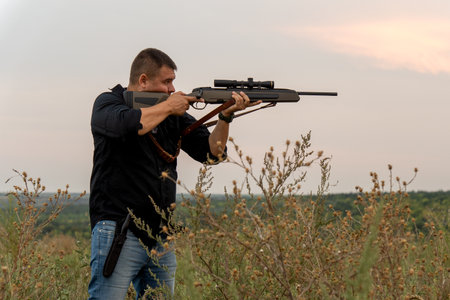 European shoots a rifle with a optics sight. Portrait of a shooter with a rifle