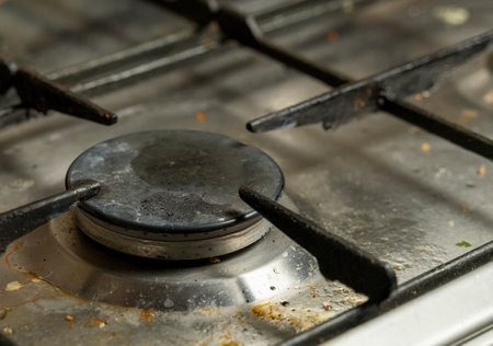 Dirty gas stove burner close up.の写真素材