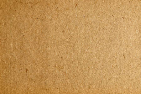 Brown cardboard background, flawed paper texture.の写真素材