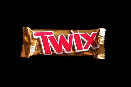 Chocolate bar Twix on a black background, top view.のeditorial素材