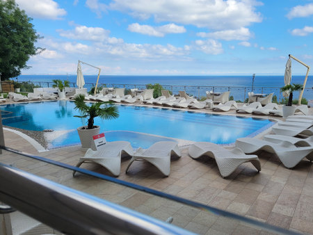 Odessa, Ukraine - September 28, 2022: Lounge area of the hotel on the beach. Swimming pool, trestle beds and tables in the recreation areaのeditorial素材
