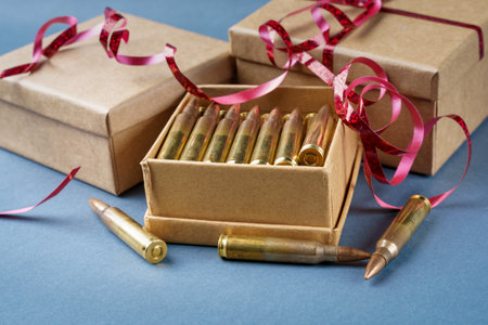 Rifle cartridges in gift box. 223 caliber ammo cartridges and three gift cardboard box. Closeup viewの写真素材