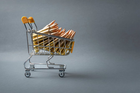 Rifle cartridges in a shopping cart. 223 caliber ammo cartridges and a small shopping basket. Side viewの写真素材